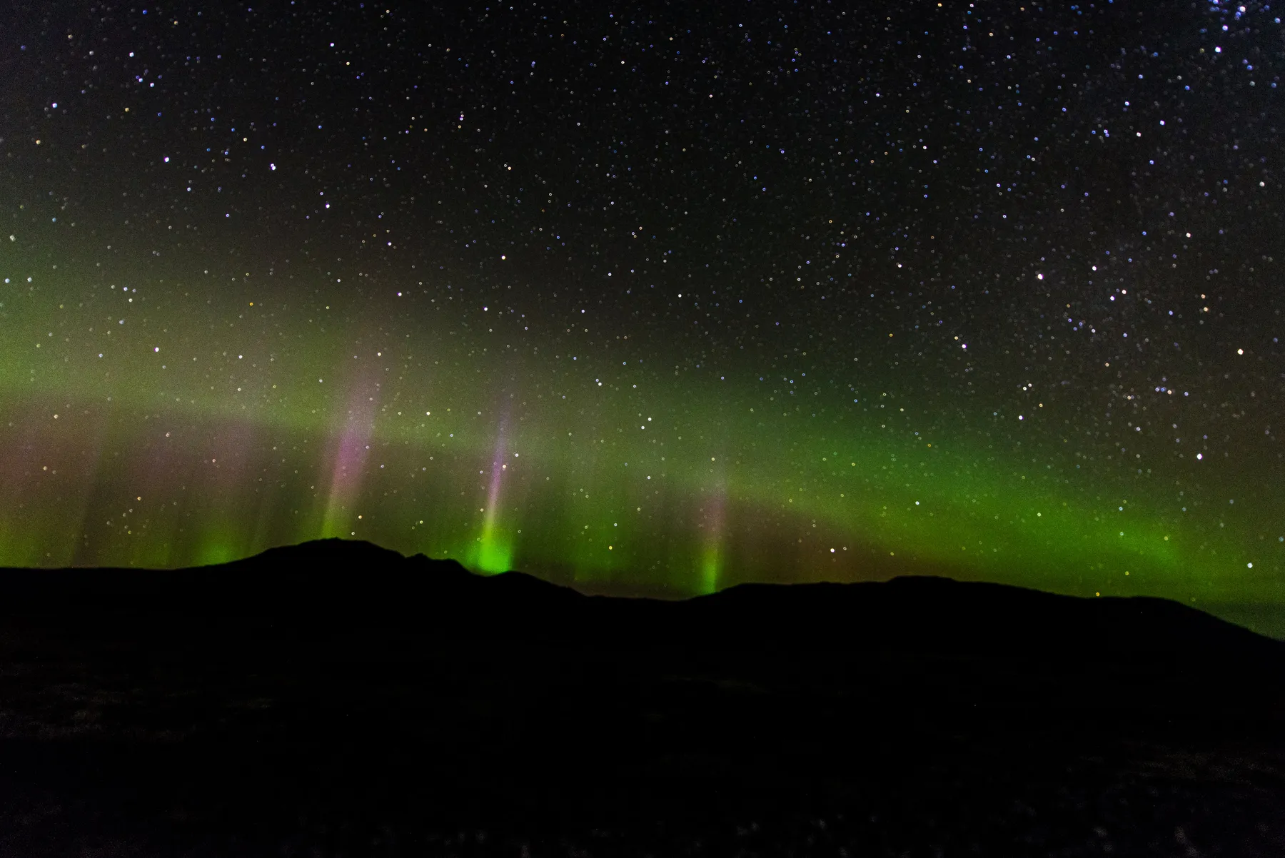 Aurora over a dark Icelandic landscape